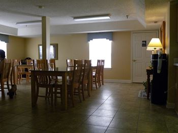 A room with a table and chairs.